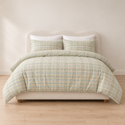 Soleil Stripe Bedding Set in Moss Horizon, sage green and cream stripe duvet cover and pillowcases on a made Queen bed