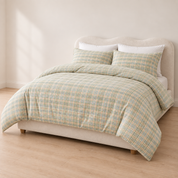 Angled view of the Soleil Stripe Bedding Set in Moss Horizon, showing the soft yarn-dyed stripe across the duvet and pillows