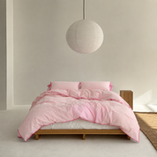 Wren Bedding Set in Blush, cotton cover with pink contrast trim on a made bed, timber frame