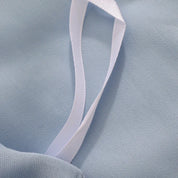 Close-up of an interior tie loop and buttery sheen on the pale blue Agnes Silk Bedding Set