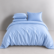 Agnes Silk Bedding Set in Powder Blue, made bed with quilt cover and pillowcases showing soft sheen