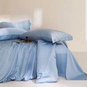 Agnes Silk Bedding Set in soft blue, pillowcases and quilt cover draped with gentle sheen and folds