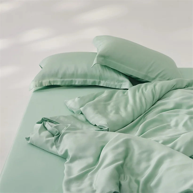 Amélie Bedding Set in soft sage green, rumpled quilt cover and pillowcases with a silky sheen