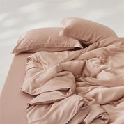 Amélie Bedding Set rumpled in dusty pink, lyocell silk sheen catching light across loose folds
