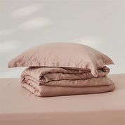 Amélie Bedding Set folded in dusty pink, quilt cover and pillowcase stacked with soft sheen