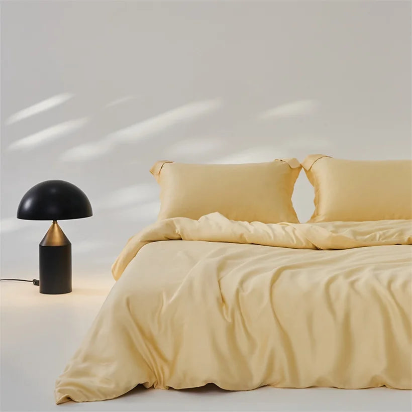 Amélie Bedding Set in soft golden yellow, styled on a bed beside a black mushroom lamp