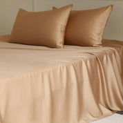 Amélie Flat Sheet Set in Caramel Latte, smooth lyocell silk sheet and pillowcases on a made bed