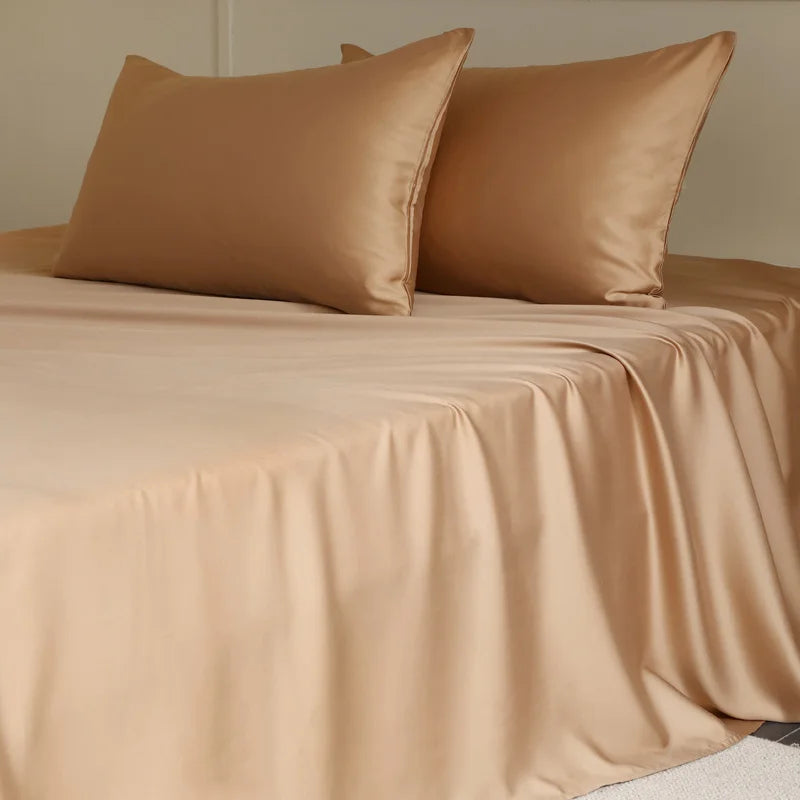 Amélie Flat Sheet Set in Caramel Latte, smooth lyocell silk sheet and pillowcases on a made bed