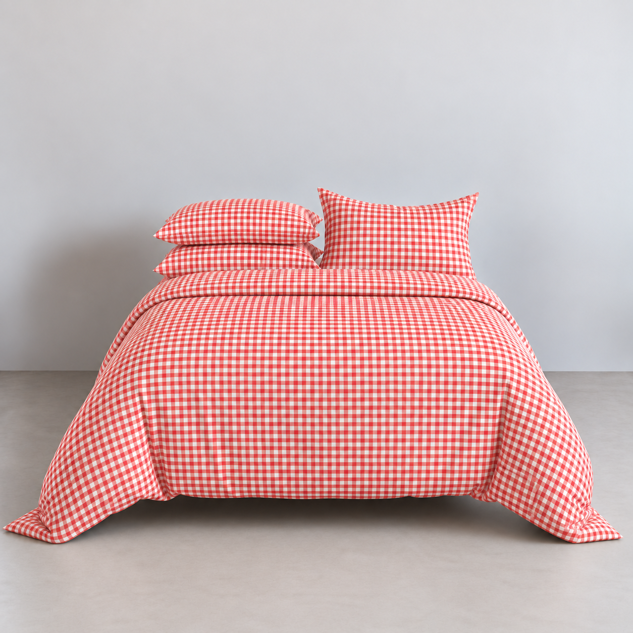 Avery Gingham Bedding Set in Cherry Red, made bed with cotton quilt cover and stacked pillowcases