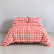Avery Gingham Bedding Set in Cherry Red, made bed with cotton quilt cover and stacked pillowcases