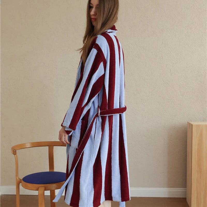Side profile of the Bambi Striped Bath Robe in cherry red and pale blue stripes, worn belted over plush cotton