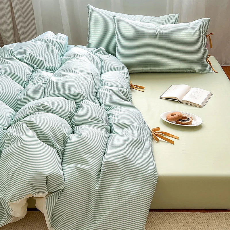Blossom Bow Bedding Set in Mint, striped quilt cover bunched with tied bow pillowcases on pale sheet