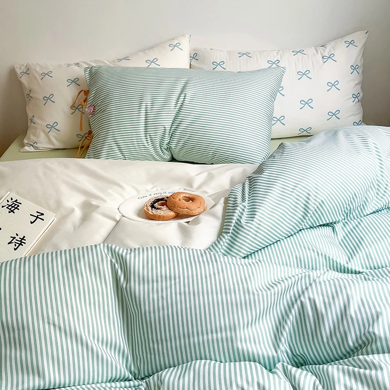 Blossom Bow Bedding Set in Mint, striped quilt cover and bow print pillowcases styled with a breakfast tray