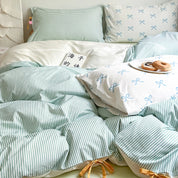 Blossom Bow Bedding Set in Mint, striped quilt cover with bow print pillowcases, styled with breakfast on the bed