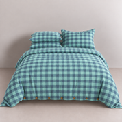 Calla Check Bedding Set in Seafoam, made bed with green and navy check quilt cover and button closure