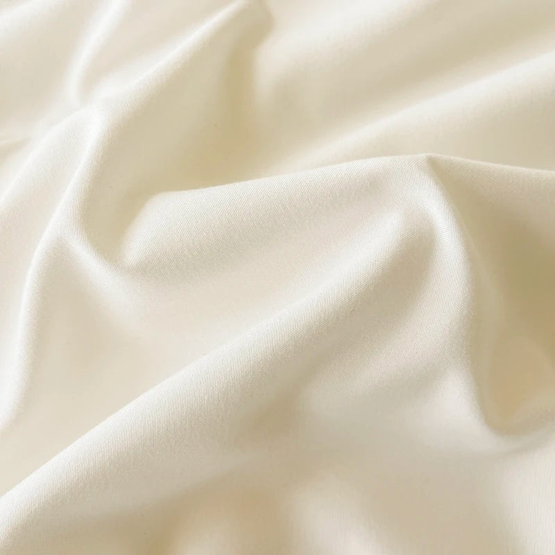 Close-up of the Camellia Ruffle Bedding Set fabric, soft ivory cotton blend gathered in smooth folds