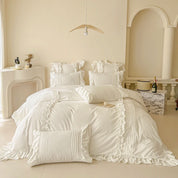 Camellia Ruffle Bedding Set in Ivory, styled on a made bed with ruffled pillowcases and pintuck cushions
