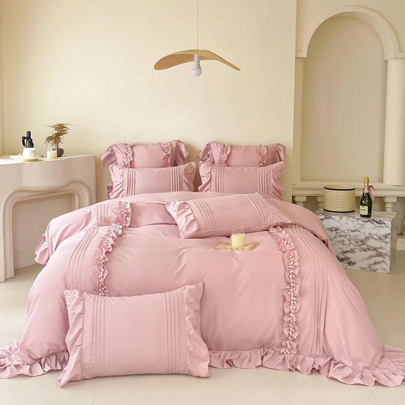 Camellia Ruffle Bedding Set in Petal Mist, dusty pink ruffled quilt cover and pillowcases on a styled bed