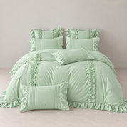 Camellia Ruffle Bedding Set in Sage Green, styled bed with ruffled pillowcases and pintuck cushions