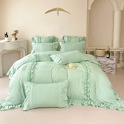 Camellia Ruffle Bedding Set in Sage Green, ruffled pillowcases and pintuck quilt cover on a made bed