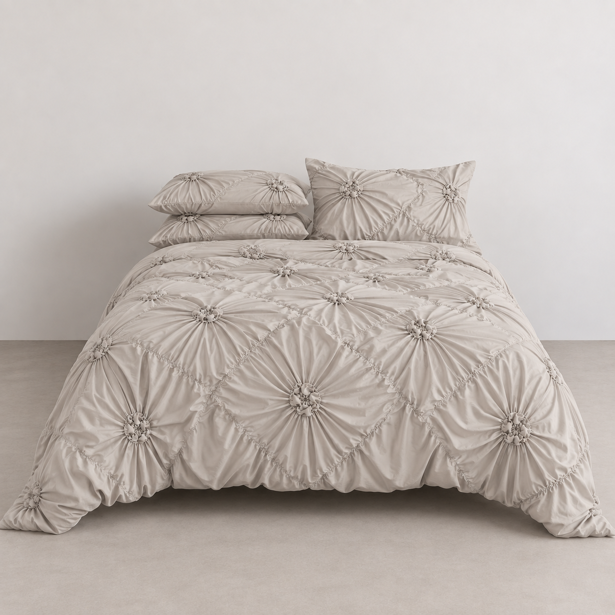 Camila Bedding Set in Beige, made bed with rosette floral texture in a diamond quilted pattern