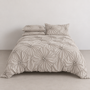 Camila Bedding Set in Beige, made bed with rosette floral texture in a diamond quilted pattern