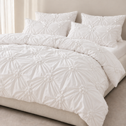 Camila Bedding Set in Ivory, rosette textured quilt cover and pillowcases styled on a made bed