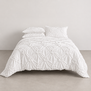 Camila Bedding Set in Ivory, made bed showing rosette texture and matching pillowcases