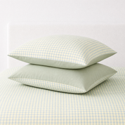 Two pillowcases from the Checkerboard Bedding Set in Blue, Green & Yellow, gingham check with sage reverse