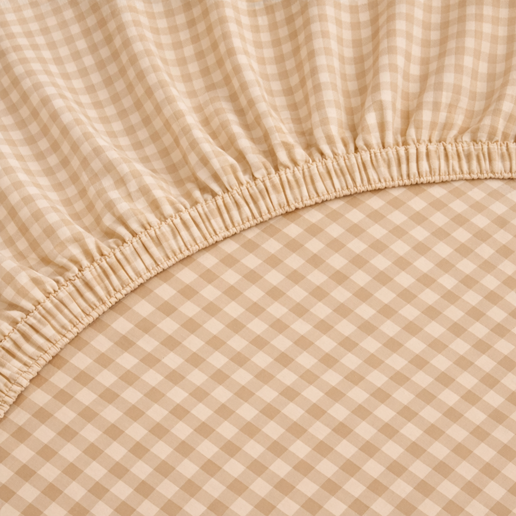 Close-up of the elasticated corner on the Checkerboard Fitted Sheet in Beige gingham check
