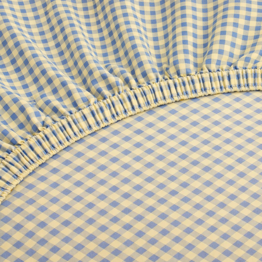 Close-up of the elasticated corner on the Checkerboard Fitted Sheet in Blue & Yellow gingham check