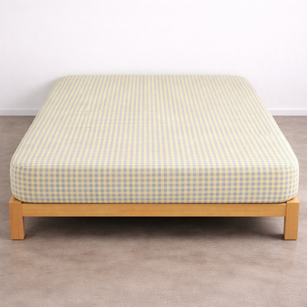 Checkerboard Fitted Sheet in Blue & Yellow gingham check, fitted over a mattress on a timber bed frame