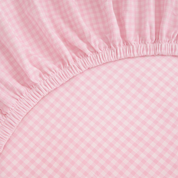 Close-up of the Checkerboard Fitted Sheet in Pink, showing the elasticated corner and gingham check weave