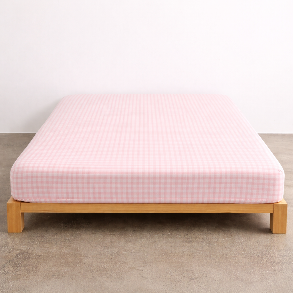 Checkerboard Fitted Sheet in Pink, soft check pattern fitted snugly over a mattress on a timber bed frame