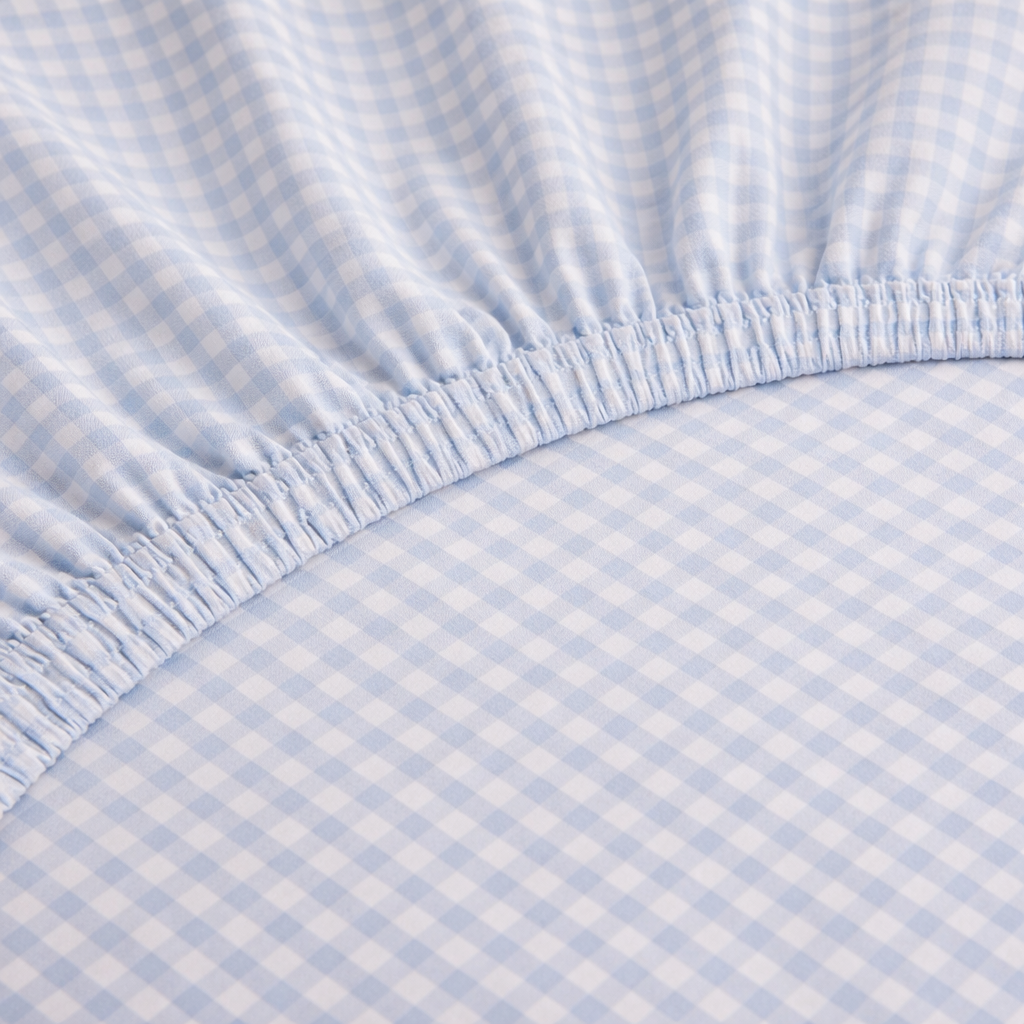 Close-up of elasticated corner on the Checkerboard Fitted Sheet in Royal Blue, showing the fine gingham check