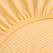 Close-up of the Checkerboard Fitted Sheet in Yellow, showing the elasticated edge and small check weave