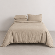 Coastal Washed Bedding Set in Caramel Cream on a made bed, crinkled cotton texture and relaxed drape