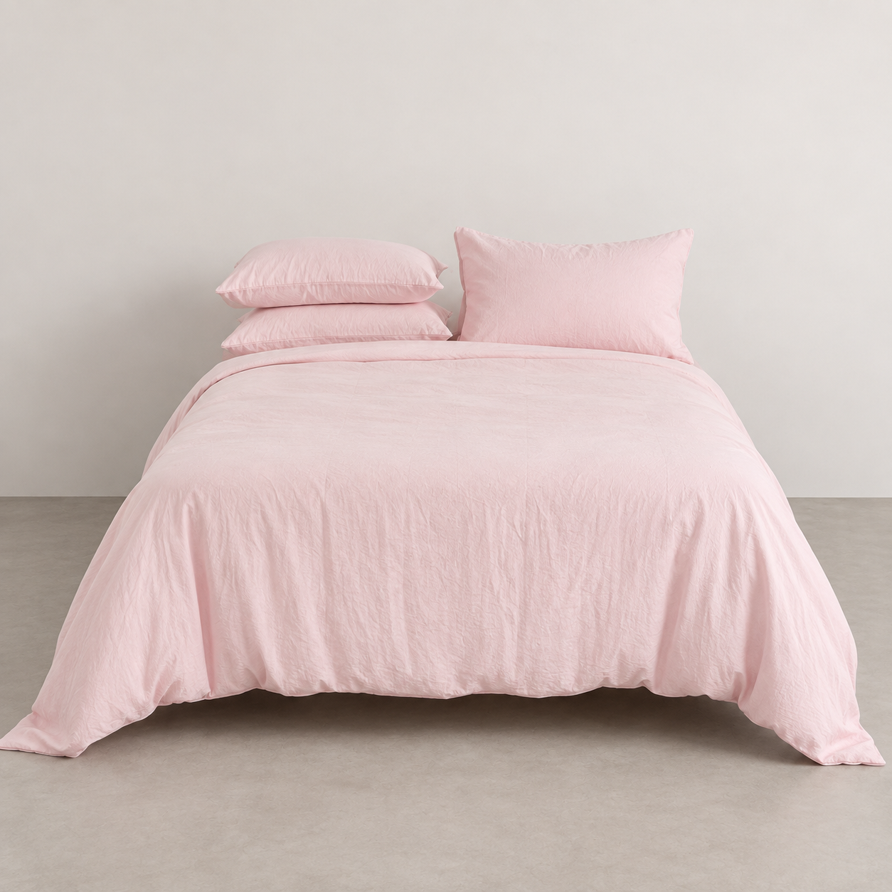 Coastal Washed Bedding Set in Rosewater Cream, soft blush quilt cover styled front on against a plain wall