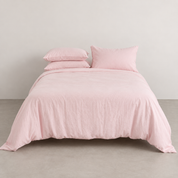 Coastal Washed Bedding Set in Rosewater Cream, soft blush quilt cover styled front on against a plain wall