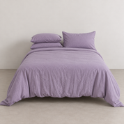 Coastal Washed Bedding Set in Soft Lavender, crinkled quilt cover and pillowcases on a made bed