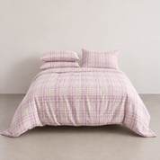 Dakota Bedding Set in Orchid Haze, woven plaid quilt cover and pillowcases on a made bed