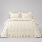 Elsie Spot Bedding Set in Chalk, made bed with scattered spot print and gathered frill edging