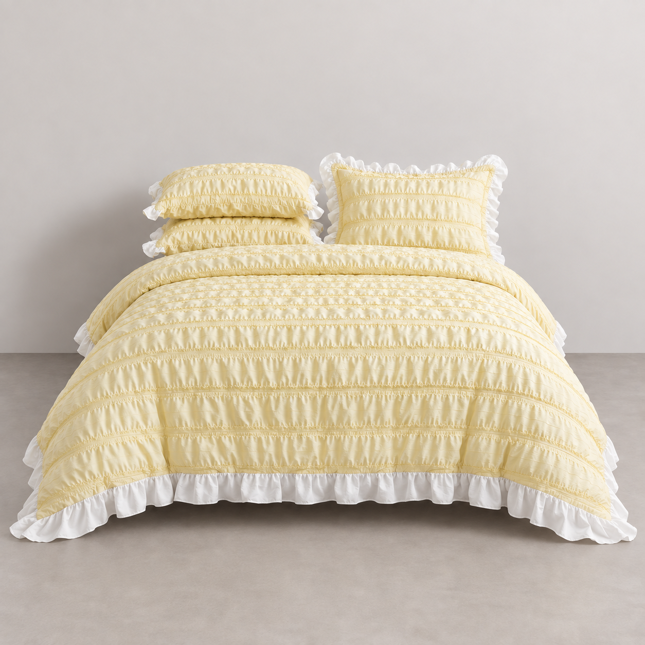 Esmé Ruffle Bedding Set in Butter, made bed with ruched texture and white frill edging
