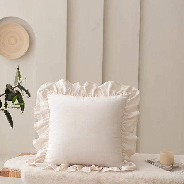 Fleur Ruffle Cushion Cover in Pure White with gathered ruffled edge, styled on a bench with candle