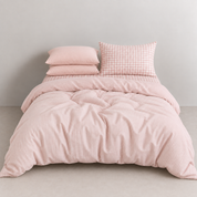 Honeythatch Gingham Bedding Set in Blush, styled bed mixing pink stripe and gingham cotton pillowcases