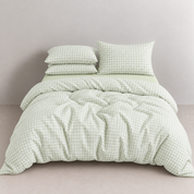 Honeythatch Gingham Bedding Set in Mint Cream, a made bed with checked quilt cover and pillowcases