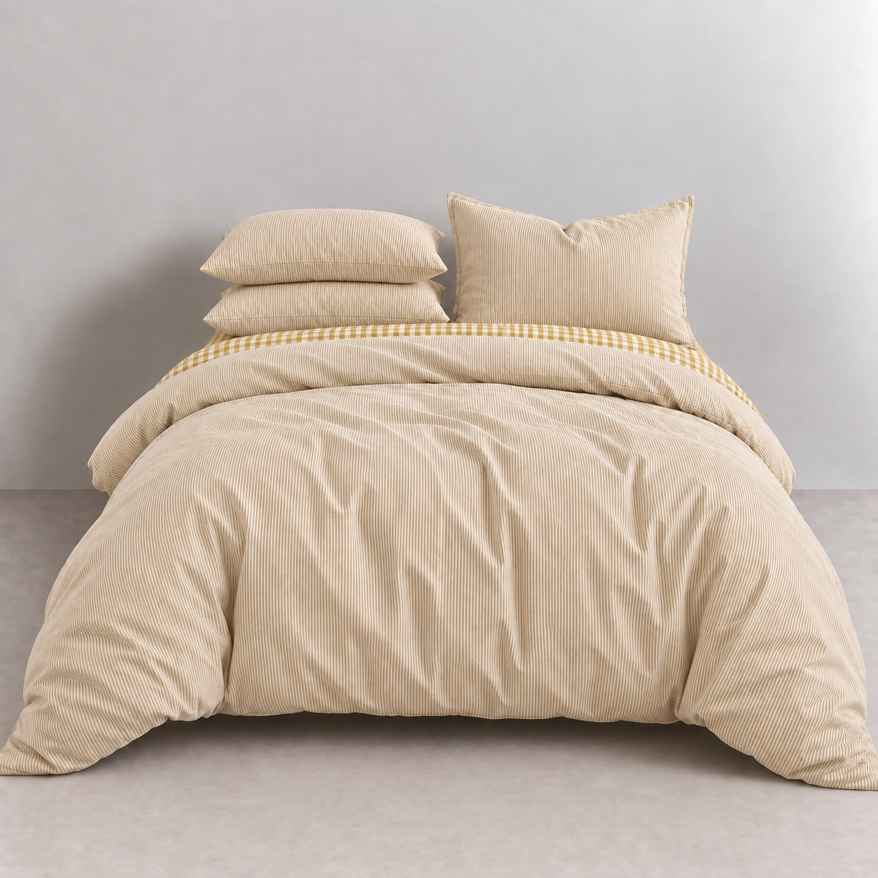 Honeythatch Gingham Bedding Set in Oatmeal, made bed with tonal stripe quilt cover and gingham trim peeking through