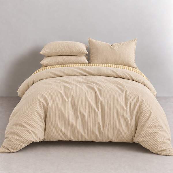 Honeythatch Gingham Bedding Set in Oatmeal, made bed with tonal stripe quilt cover and gingham trim peeking through