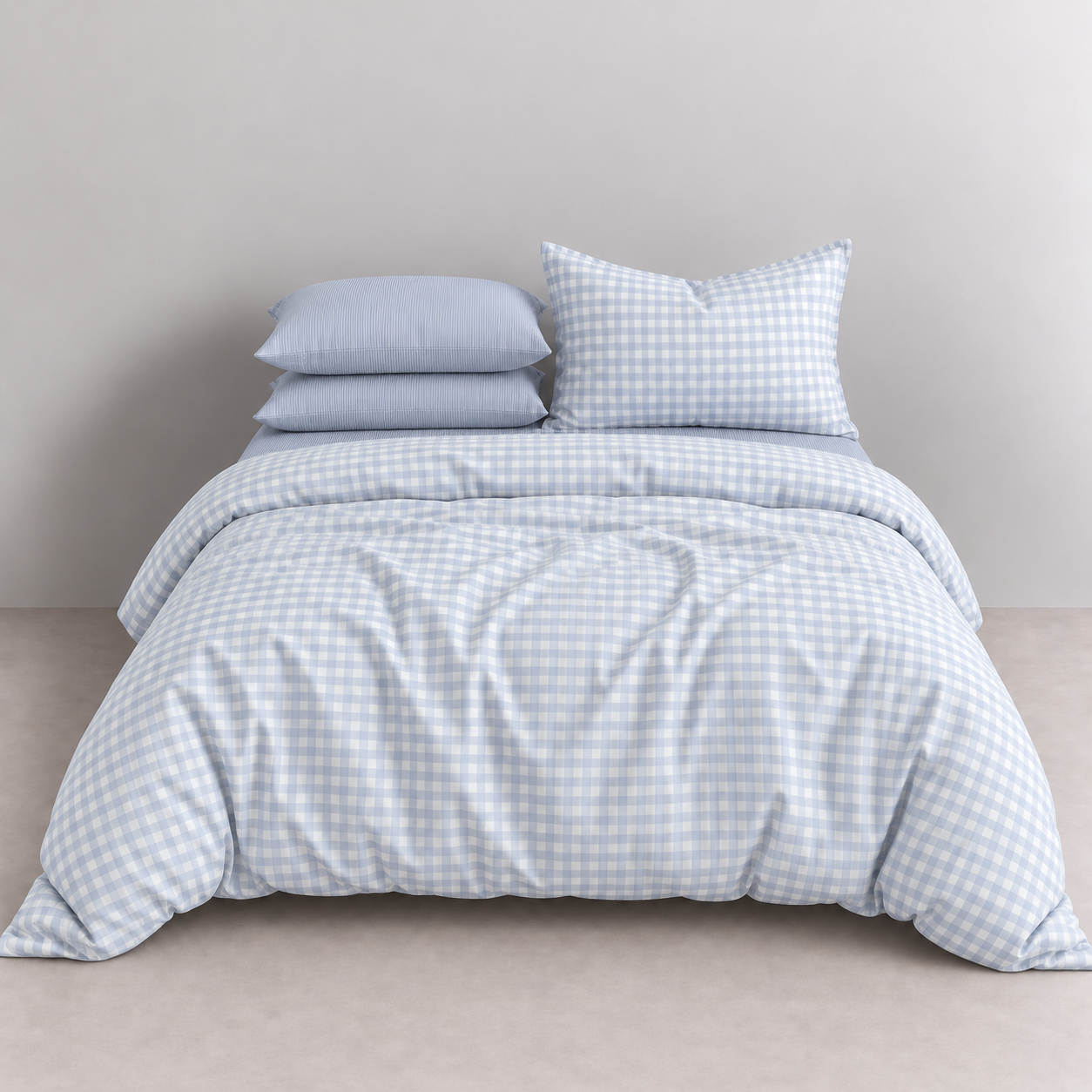 Honeythatch Gingham Bedding Set in Sky, pale blue check quilt cover with striped pillowcases on a made bed