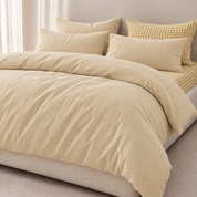 Honeythatch Gingham Bedding Set styled bed with tonal stripe quilt cover and mustard gingham pillowcase accent